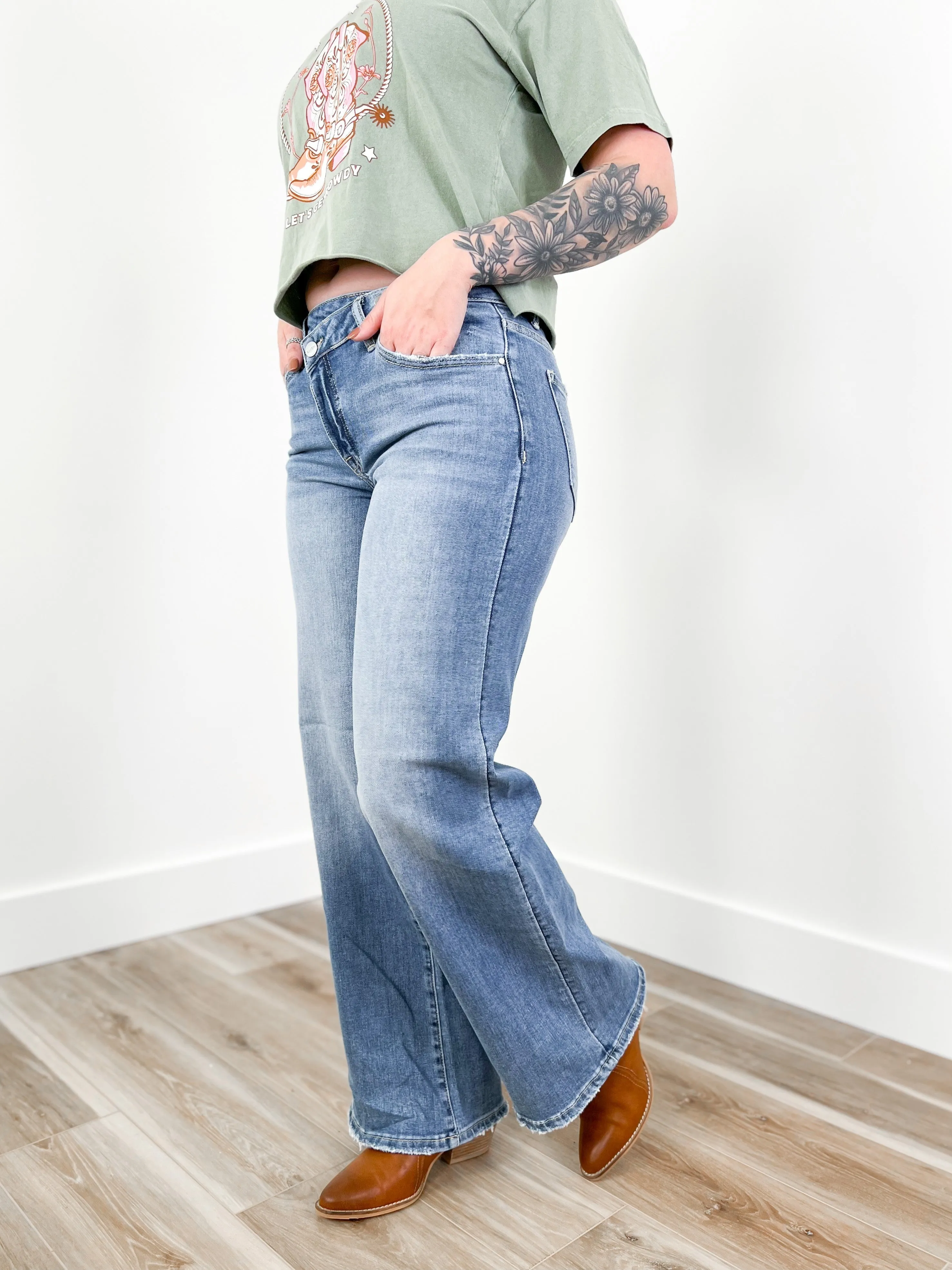Risen Mid Rise Medium Wash Wide Leg Crossover Jeans