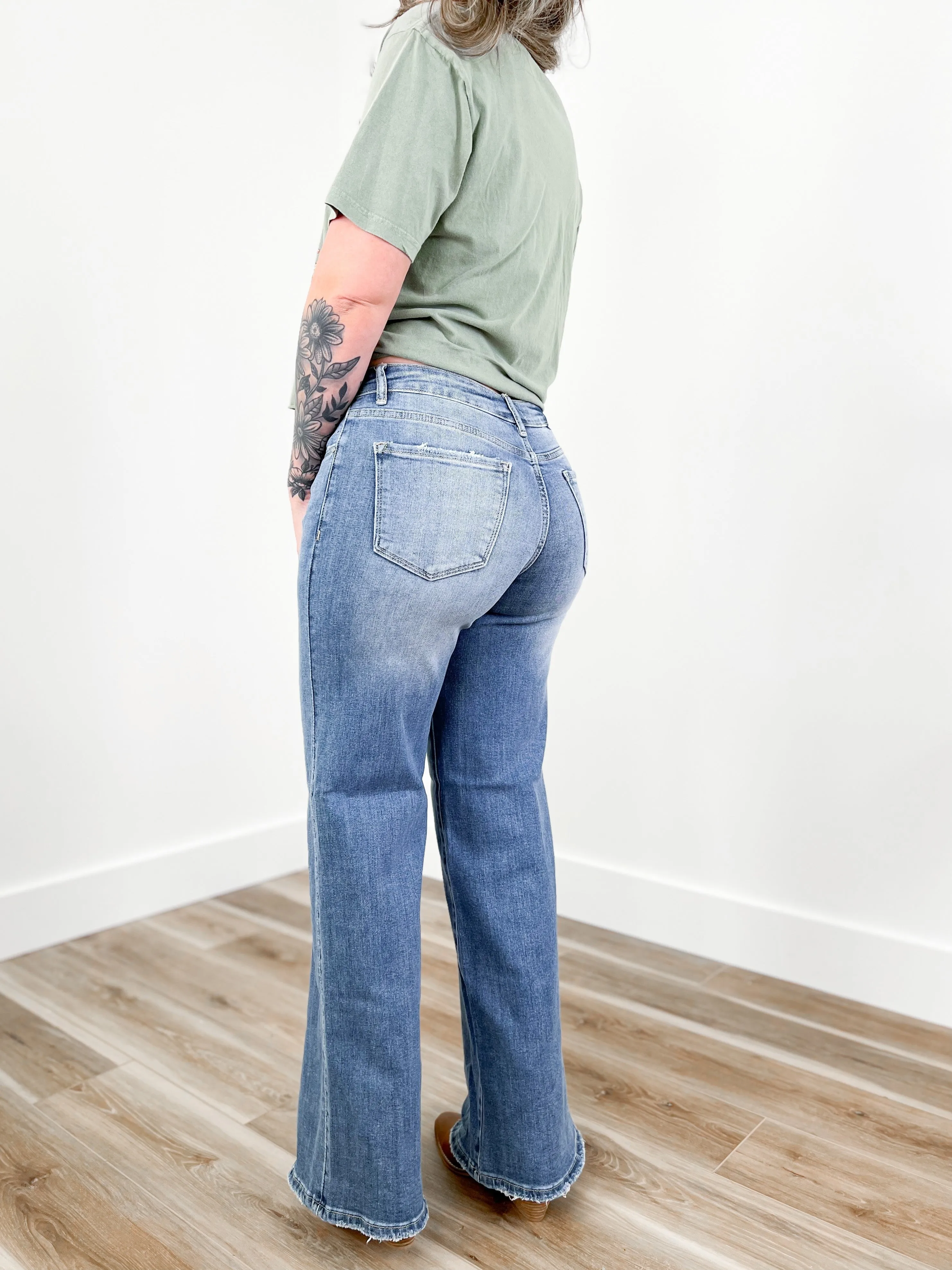 Risen Mid Rise Medium Wash Wide Leg Crossover Jeans