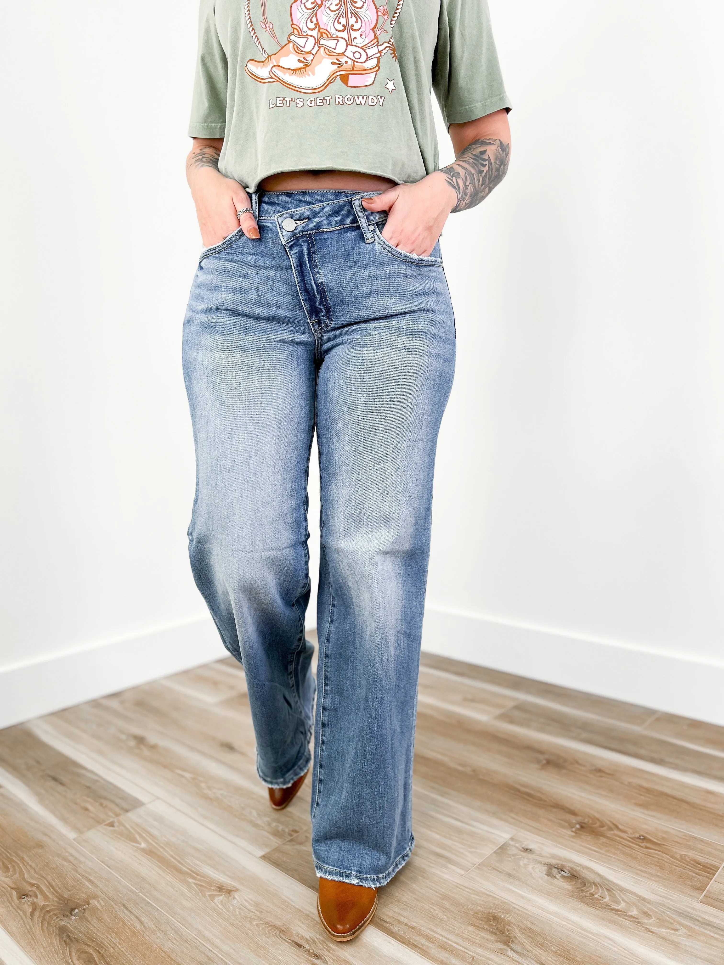 Risen Mid Rise Medium Wash Wide Leg Crossover Jeans